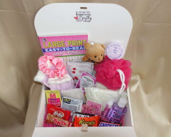 Menstrual subscription box with feminine pads, delicious healthy snacks, and soothing comfort items in a stylish box.