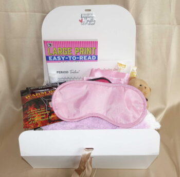 First menstrual kit with feminine products, delicious healthy snacks, and soothing comfort items in a stylish box.