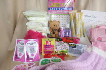 First menstruation kit care package with feminine essential pads, tampons, spa worthy products, and sweet delectables.